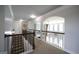 Upper level hallway with railing and archways, offering views of the lower floor at 293 Ironwood Dr, Stockbridge, GA 30281