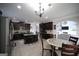 Bright kitchen features dark cabinets, stainless steel appliances, granite countertops, and an island with seating at 293 Ironwood Dr, Stockbridge, GA 30281