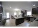 The bright eat-in kitchen has dark cabinets, stainless steel appliances, granite countertops, and an island at 293 Ironwood Dr, Stockbridge, GA 30281