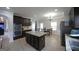 The kitchen has dark cabinets, stainless steel appliances, granite countertops, a kitchen island and an eat in area at 293 Ironwood Dr, Stockbridge, GA 30281