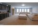 Expansive living room with plush carpeting, neutral-toned walls, and a wet bar with granite countertops at 293 Ironwood Dr, Stockbridge, GA 30281