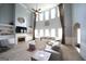 Bright living room featuring a high ceiling, fireplace, a large TV and a comfortable sectional sofa at 293 Ironwood Dr, Stockbridge, GA 30281