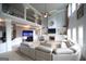 Open living room featuring high ceilings, a fireplace, built-in shelving, and an aquarium at 293 Ironwood Dr, Stockbridge, GA 30281