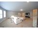 Large living room featuring neutral walls, plush carpeting, and a comfortable sectional sofa for relaxation and entertainment at 293 Ironwood Dr, Stockbridge, GA 30281