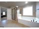 Bright main bathroom showcases a stand-up shower, soaking tub, and ceramic tile flooring at 293 Ironwood Dr, Stockbridge, GA 30281