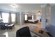 Spacious main bedroom with neutral walls, a ceiling fan, and a sitting area with a dark leather chair at 293 Ironwood Dr, Stockbridge, GA 30281