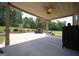 Covered patio features an outdoor fireplace, ceiling fan, and views of the lush, green backyard at 293 Ironwood Dr, Stockbridge, GA 30281