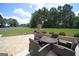 The backyard patio features a gas fireplace, outdoor seating, and a lush lawn at 293 Ironwood Dr, Stockbridge, GA 30281