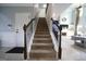 Inviting staircase leads to the upper level, showcasing a blend of carpet and hardwood floors at 293 Ironwood Dr, Stockbridge, GA 30281