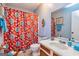 Traditional bathroom featuring colorful accents, a toilet, vanity, and a shower with a floral patterned curtain at 44 Twiggs Cor, Peachtree City, GA 30269