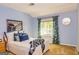 Cozy bedroom features blue walls, carpeted floors, natural light from the windows, and decorative accents at 44 Twiggs Cor, Peachtree City, GA 30269