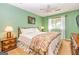 Charming bedroom with green walls, carpet flooring, a ceiling fan, and natural light from the windows at 44 Twiggs Cor, Peachtree City, GA 30269