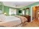 Bright bedroom with green walls, carpet, ceiling fan, and features a TV along with a dresser at 44 Twiggs Cor, Peachtree City, GA 30269