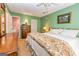 Bedroom with green walls, carpeted floors, offering a peaceful atmosphere with a view to the en-suite bathroom at 44 Twiggs Cor, Peachtree City, GA 30269