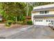 Exterior shot of home highlighting attached garage and mature trees at 44 Twiggs Cor, Peachtree City, GA 30269