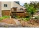 Two-story townhome featuring a charming front yard, wooden deck, and walkway at 44 Twiggs Cor, Peachtree City, GA 30269