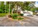 Charming exterior view of home with lush landscaping and a two-car garage at 44 Twiggs Cor, Peachtree City, GA 30269