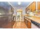 Functional kitchen with wooden cabinets, tile floors, and view of dining area at 44 Twiggs Cor, Peachtree City, GA 30269