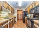 Classic kitchen featuring wood cabinetry, tile flooring, and essential appliances at 44 Twiggs Cor, Peachtree City, GA 30269