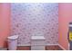 Traditional laundry room featuring patterned wallpaper, neutral flooring, a utility sink, and a washing machine hook-up at 44 Twiggs Cor, Peachtree City, GA 30269