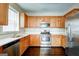 Well-lit kitchen features stainless appliances, light countertops and wood cabinets at 1643 Jackson Way, Atlanta, GA 30318
