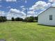 House with green grass, trees and a trampoline in the backyard at 3014 Bowdon Tyus Rd, Bowdon, GA 30108