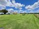 Extensive green backyard featuring a charming white home with a well-kept lawn and surrounding scenery at 3014 Bowdon Tyus Rd, Bowdon, GA 30108