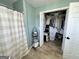 Bathroom featuring wood look flooring, shower with curtain, and open closet at 3014 Bowdon Tyus Rd, Bowdon, GA 30108