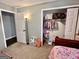 Bedroom with carpet, an open closet filled with clothes and doorway visible at 3014 Bowdon Tyus Rd, Bowdon, GA 30108