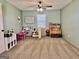 A bedroom with carpet, a play kitchen and toy table and chairs at 3014 Bowdon Tyus Rd, Bowdon, GA 30108