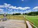 Relaxing on the deck, this outdoor area features a table and chairs, overlooking a picturesque open field at 3014 Bowdon Tyus Rd, Bowdon, GA 30108
