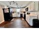 Bright kitchen featuring modern black appliances, white cabinetry, and hardwood floors at 3014 Bowdon Tyus Rd, Bowdon, GA 30108