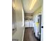 Functional laundry room with modern washer, dryer, storage shelves, and a utility sink at 3014 Bowdon Tyus Rd, Bowdon, GA 30108