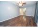 A bedroom with hardwood floors, ceiling fan, and view into the attached bathroom at 616 Inman Rd # B, Fayetteville, GA 30215