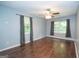 Bedroom with hardwood floors, dual windows for natural light, and classic ceiling fan at 616 Inman Rd # B, Fayetteville, GA 30215