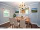 Elegant dining room with a chandelier, hardwood floors, and a large dining table set for a meal at 616 Inman Rd # B, Fayetteville, GA 30215
