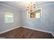 Dining room with hardwood floors, a chandelier, and a view into the kitchen at 616 Inman Rd # B, Fayetteville, GA 30215