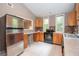 Kitchen features stainless steel refrigerator, tiled countertops and backsplash, and wooden cabinets at 616 Inman Rd # B, Fayetteville, GA 30215