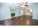 Spacious living room with hardwood floors and a fireplace, open to the dining area at 616 Inman Rd # B, Fayetteville, GA 30215