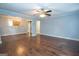 Spacious living room with hardwood floors, a ceiling fan, and a view into the adjacent room at 616 Inman Rd # B, Fayetteville, GA 30215