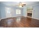 Bright living room features hardwood floors, a fireplace, and a ceiling fan at 616 Inman Rd # B, Fayetteville, GA 30215