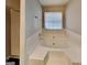 Clean bathroom with a large soaking tub and a window for natural light at 6630 Pole Creek Dr, Lithonia, GA 30058