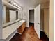 Bathroom featuring a long vanity, mirror, wood floors and walk-in closet at 6630 Pole Creek Dr, Lithonia, GA 30058
