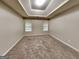 Cozy carpeted bedroom with tray ceilings, two windows offering natural light at 6630 Pole Creek Dr, Lithonia, GA 30058
