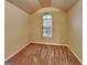 Cozy carpeted bedroom with a vaulted ceiling and a unique arched window at 6630 Pole Creek Dr, Lithonia, GA 30058