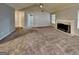 Open-concept living room with fireplace and carpet, filled with natural light at 6630 Pole Creek Dr, Lithonia, GA 30058