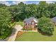 Spacious property showcasing a brick home with lush landscaping and surrounding mature trees at 4147 Alayna Lee Cir, Mcdonough, GA 30252