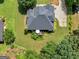 Aerial shot displays the beautifully landscaped backyard, patio and lush green lawn at 4147 Alayna Lee Cir, Mcdonough, GA 30252