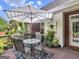 Outdoor deck with a striped umbrella, glass table, chairs, potted plants, and access to the house at 4147 Alayna Lee Cir, Mcdonough, GA 30252