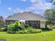 Back exterior features a brick veneer and expansive deck with a lush garden at 4147 Alayna Lee Cir, Mcdonough, GA 30252